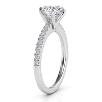 June - Side view.  Centre round diamond in a six claw setting.  