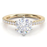 June - Yellow gold six claw diamond engagement ring with a round brilliant centre diamond and diamonds set along the band.