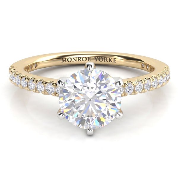 June - Yellow gold six claw diamond engagement ring with a round brilliant centre diamond and diamonds set along the band.