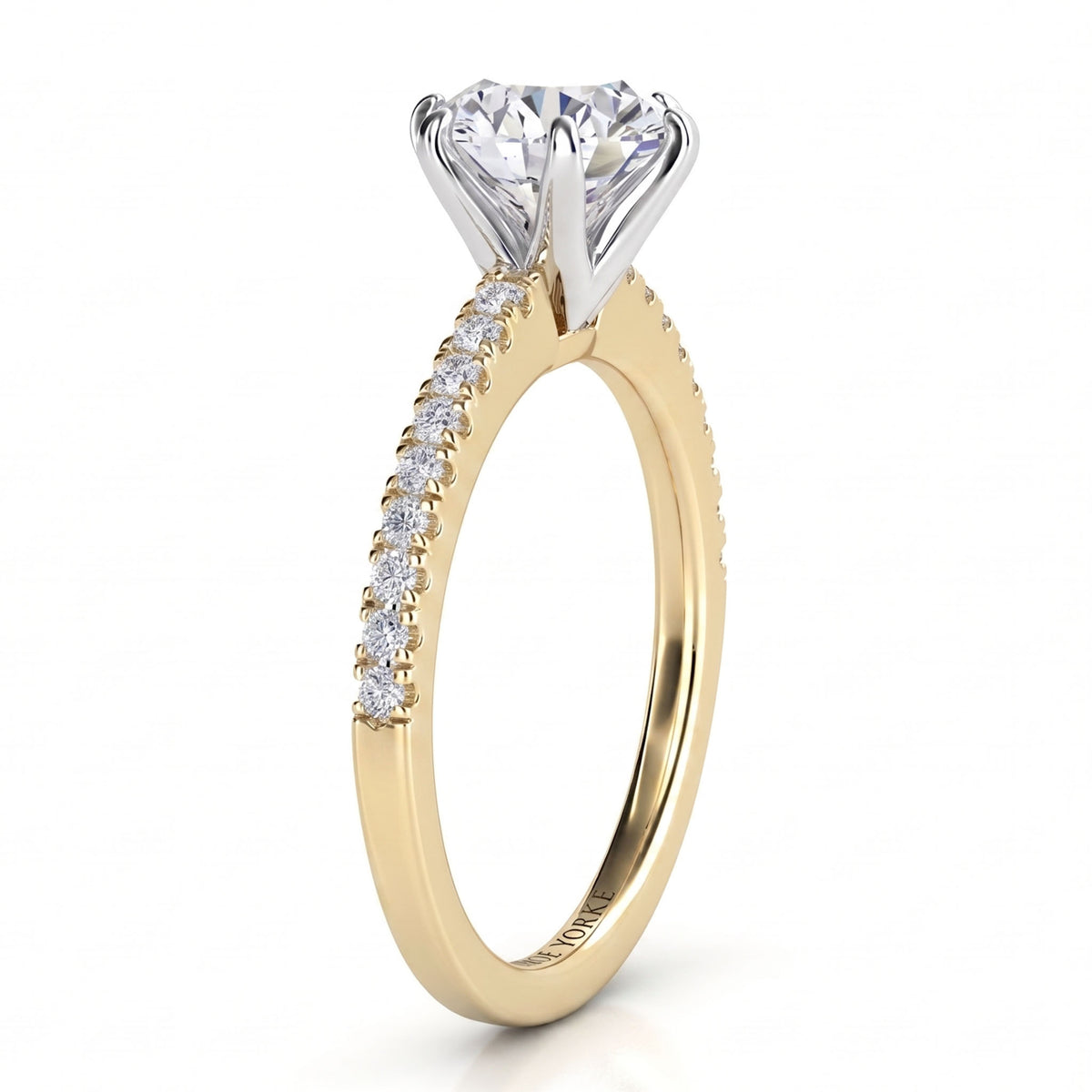 June - Yellow gold round brilliant cut diamond engagement ring, side view.