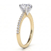 June - Yellow gold round brilliant cut diamond engagement ring, side view.