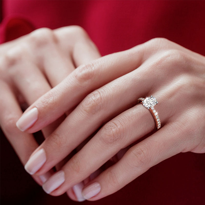 Gold Engagement Ring shown in a lady's hand. 