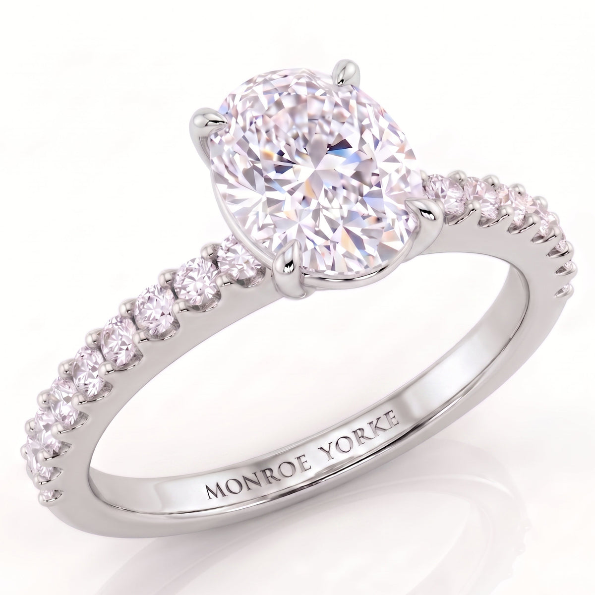 Kendall - White gold or Platinum Oval diamond engagement ring wtih diamonds on the band.  Ring by Monroe Yorke Diamonds. 