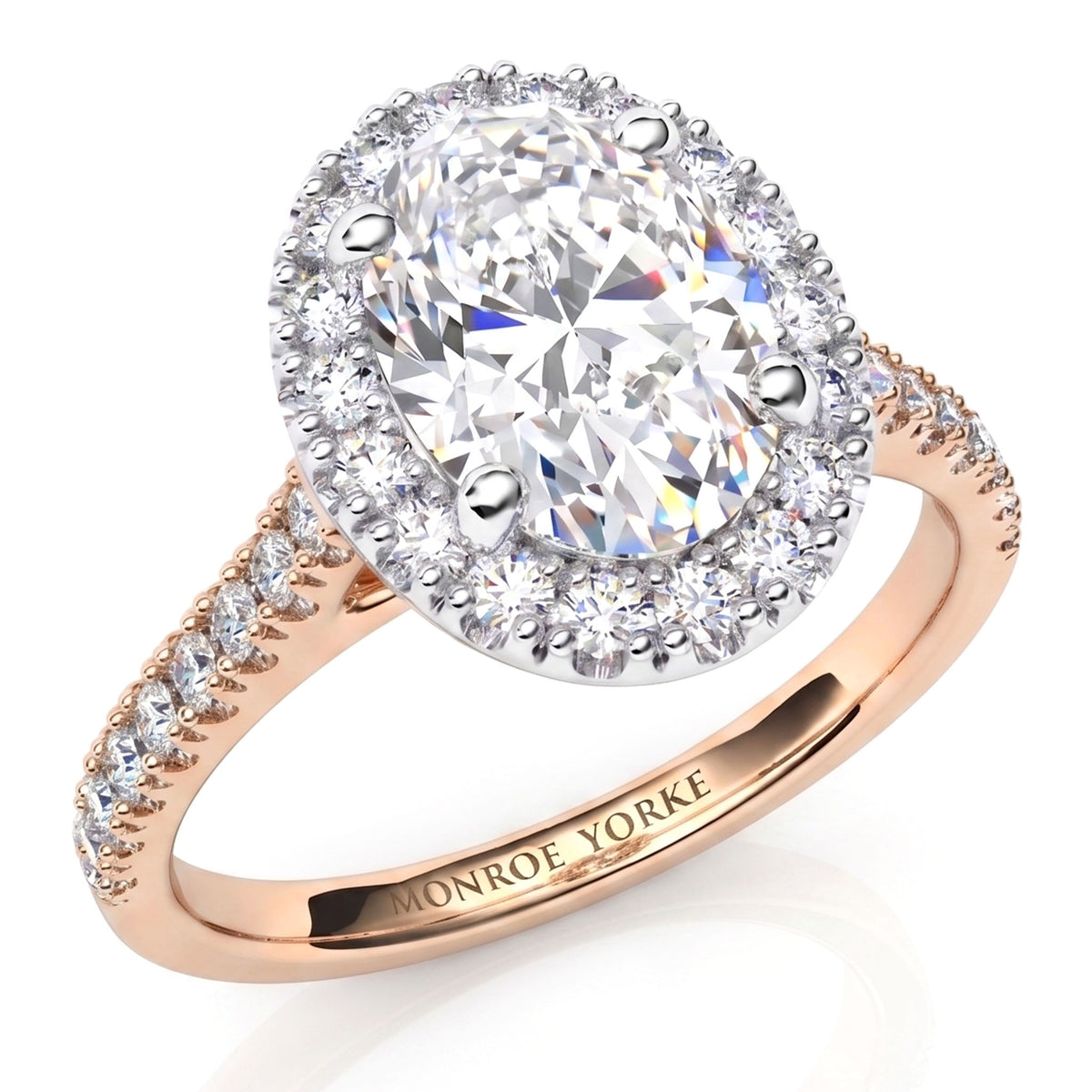 An oval halo engagement ring featuring a large round brilliant-cut center stone surrounded by a halo of smaller round stones, set on a rose gold band with pavé accents. 
