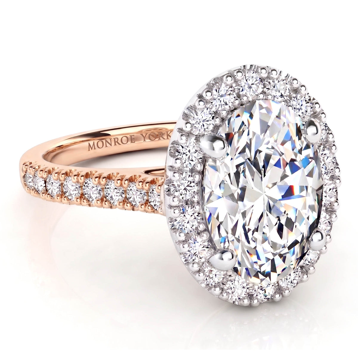 An oval diamond halo ring with a rose gold band, featuring a large oval-cut center diamond surrounded by a halo of small diamonds, with additional diamonds along the band. 