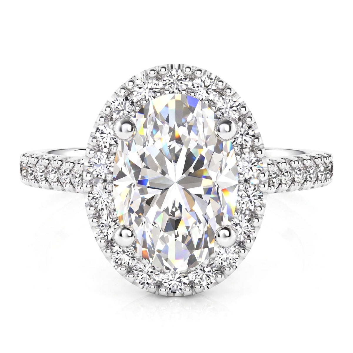 An oval halo engagement ring in white gold or platinum - featuring a large brilliant-cut center stone surrounded by a halo of smaller round stones, set on a diamond-cut band with pavé accents, shown on a white background.
