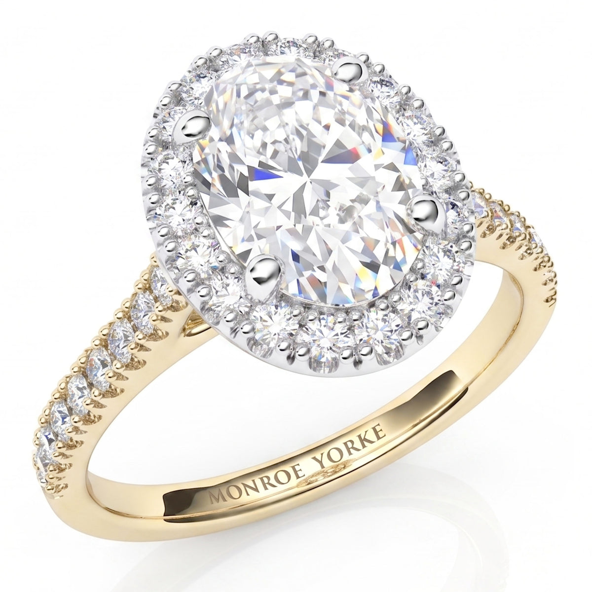 A yellow gold halo ring featuring a large oval-cut clear center stone surrounded by a halo of smaller round stones, with additional small stones along the split shank. 