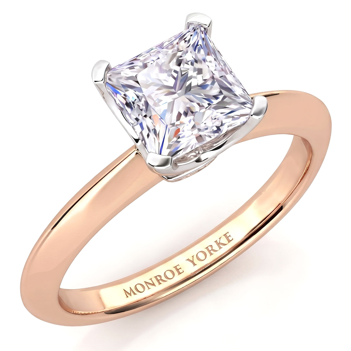 A princess cut diamond engagement ring in a rose gold band with a white metal prong setting, featuring the engraved brand name 'MONROE YORKE' on the inside of the band, set against a clean white background.