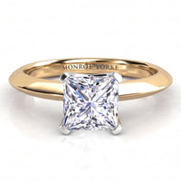 A princess cut diamond engagement ring in a polished yellow gold band, featuring a white metal four-prong setting. The inside of the band is engraved with the name 'MONROE YORKE'.