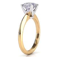 A solitaire engagement ring featuring a princess cut diamond in a white metal prong setting on a polished yellow gold band, shown against a plain white background.