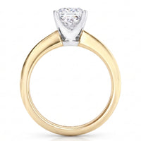 A yellow gold solitaire engagement ring with a princess cut diamond set in a white metal prong setting, shown on a clean white background.