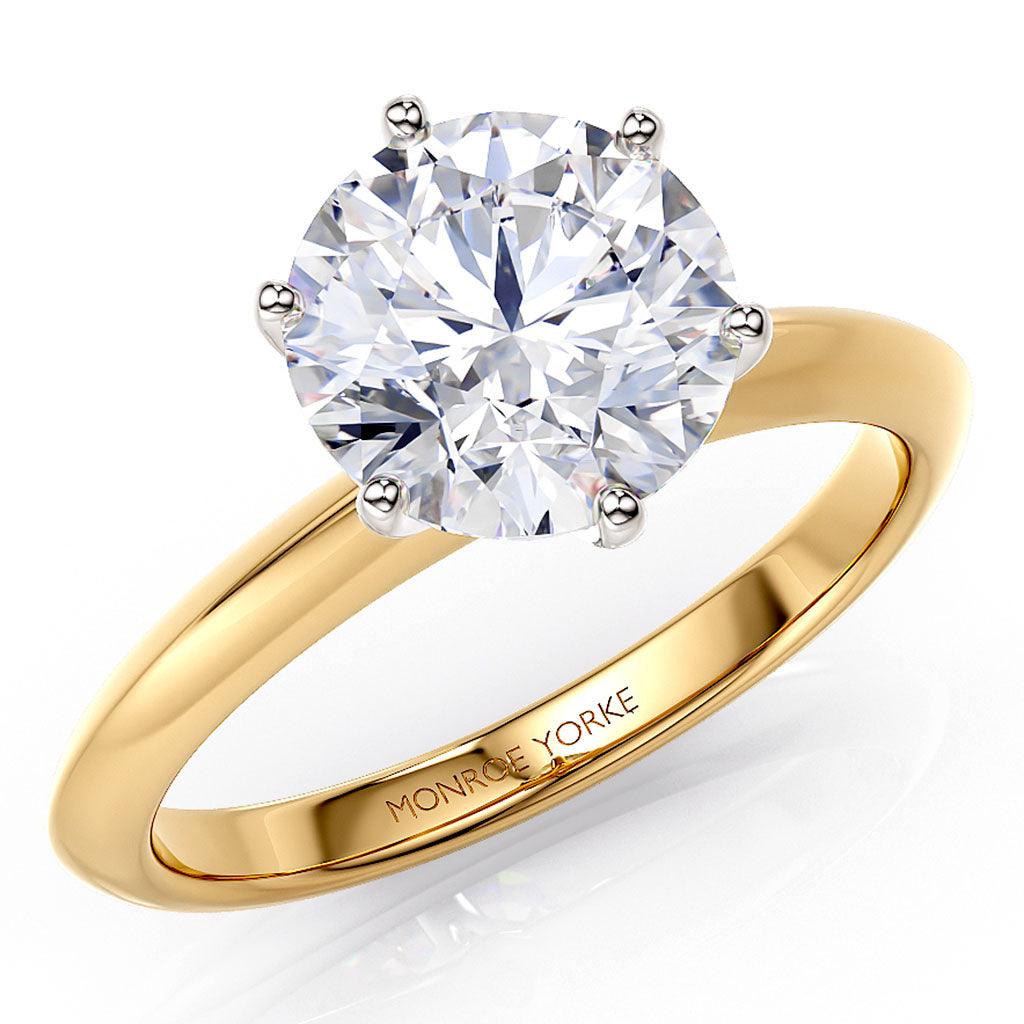 Love in 18ct yellow gold, angled view showing the knife edge band and white gold six claw setting