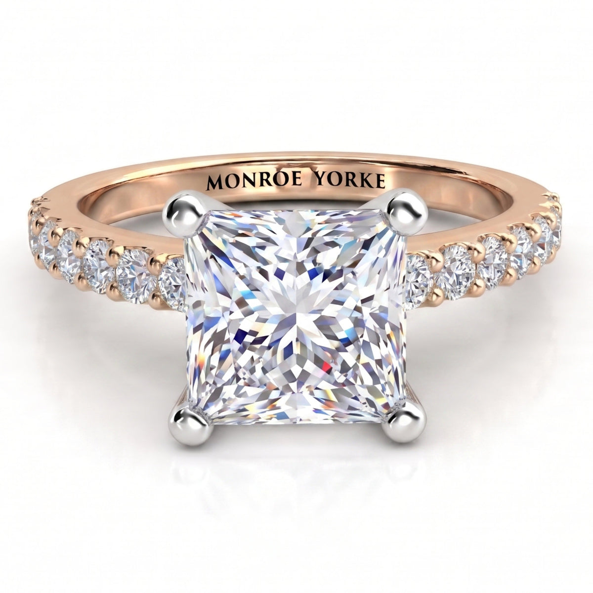 Lutèce rose gold engagement ring, front view of the princess cut centre diamond with a row of small round diamonds down each shoulder.