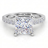 Lutèce engagement ring in white gold or platinum, front view of the princess cut centre diamond with a row of small round diamonds down each shoulder.