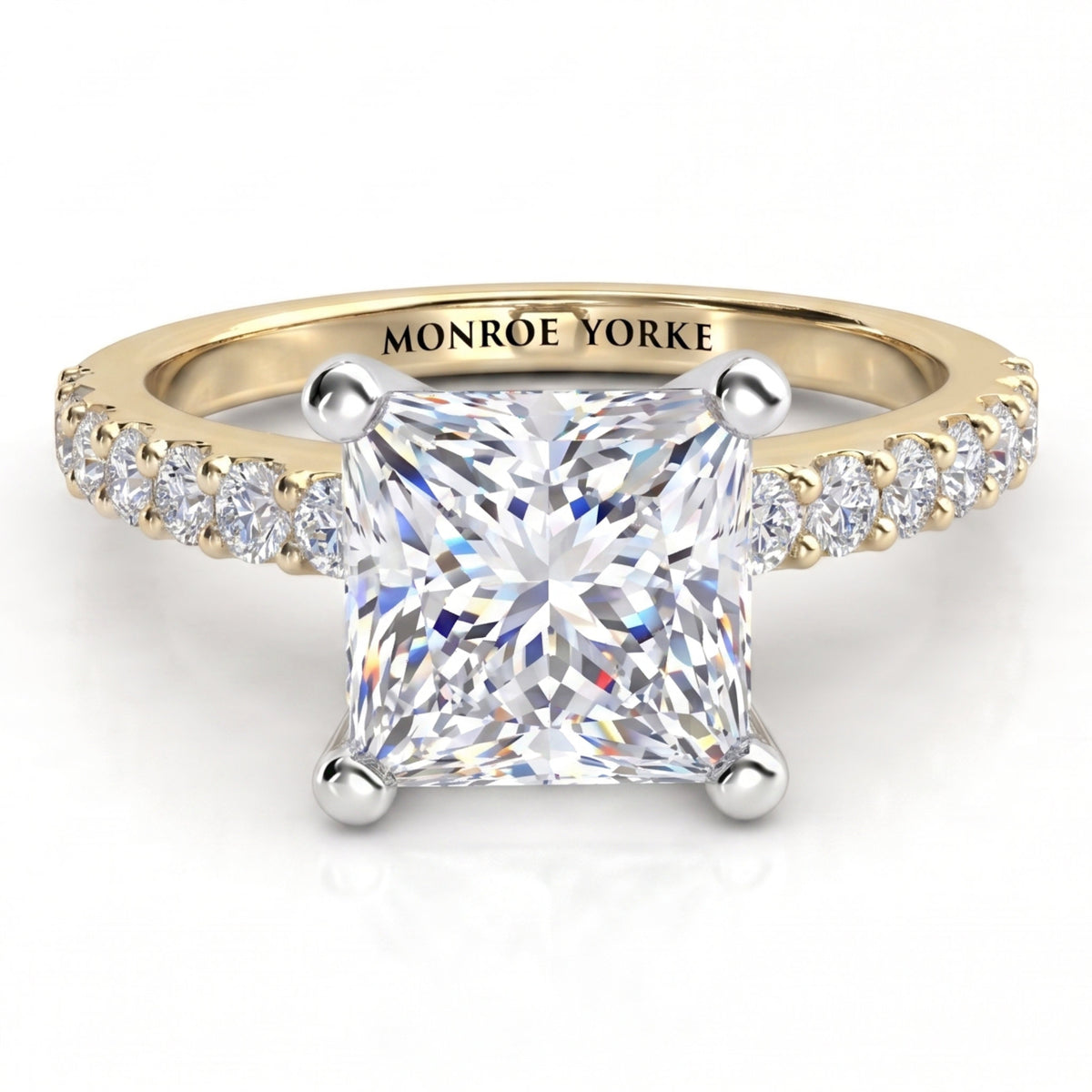 Lutèce yellow gold engagement ring, front view of the princess cut centre diamond with a row of small round diamonds down each shoulder.