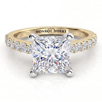 Lutèce yellow gold engagement ring, front view of the princess cut centre diamond with a row of small round diamonds down each shoulder.
