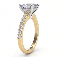 Lutèce yellow gold engagement ring, side profile showing the four claw setting, the white metal setting head and the micro claw set shoulders.