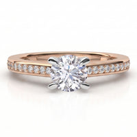 A rose gold solitaire engagement ring with a round brilliant-cut center diamond and a pavé band set with small diamonds.
