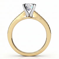 A yellow gold ring with a four-prong setting holding a round diamond, shown on a clean white background.