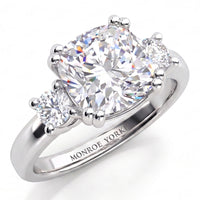 Meghan Markle engagement ring in all white gold or platinum. Three diamond ring with centre GIA certified cushion cut diamond and round diamonds on either side. White Gold or Platinum