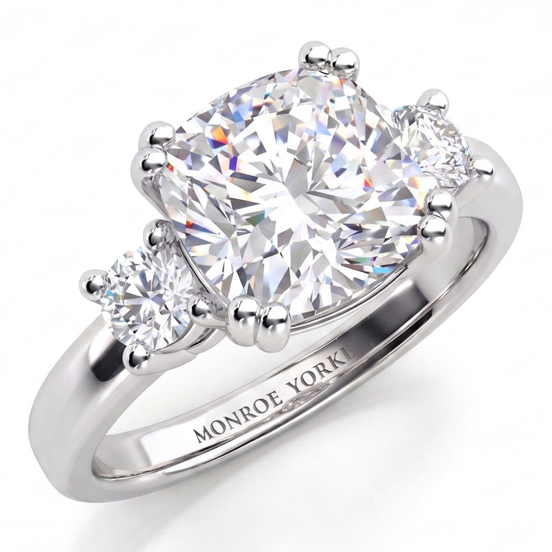 Meghan Markle engagement ring in all white gold or platinum. Three diamond ring with centre GIA certified cushion cut diamond and round diamonds on either side. White Gold or Platinum