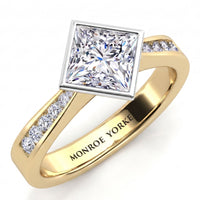 Nash - Yellow gold band with channel set diamonds along the shoulders and a princess cut centre diamond.