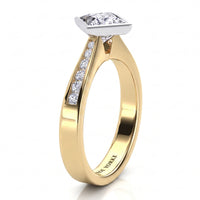 Nash - Yellow gold princess cut diamond engagement ring, side view showing the channel set band.