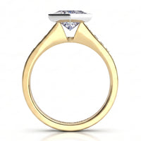 Nash - Yellow gold ring with the princess cut centre diamond held in a rub-over bezel.