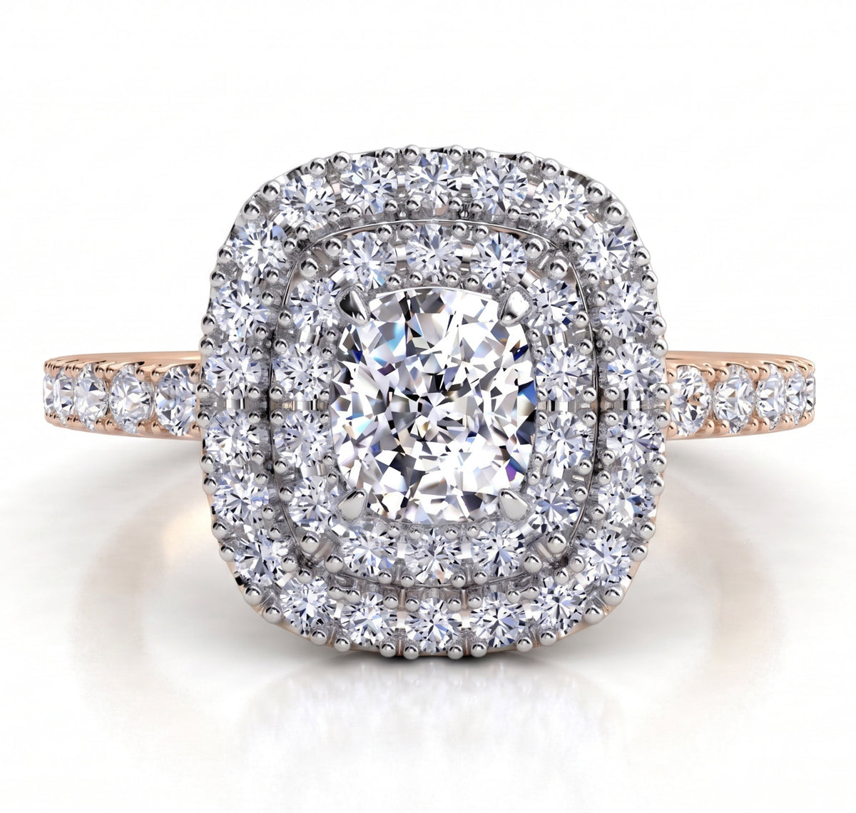 Norah double halo engagement ring with a rose gold band, top view showing the cushion cut centre diamond ringed by an inner and outer halo of round brilliant diamonds.
