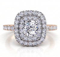 Norah double halo engagement ring with a rose gold band, top view showing the cushion cut centre diamond ringed by an inner and outer halo of round brilliant diamonds.
