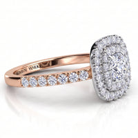 Norah cushion cut double halo engagement ring with a rose gold band, angled side view showing the depth of the two halos in the white metal setting head.