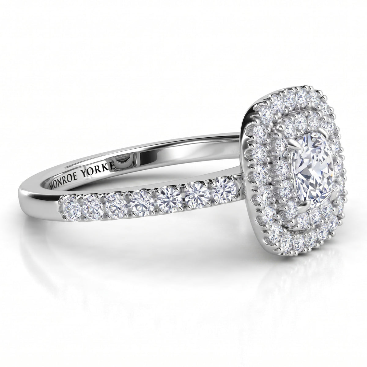 Norah cushion cut double halo engagement ring in white gold or platinum, angled side view showing the depth of the two halos and the claw set shoulders.