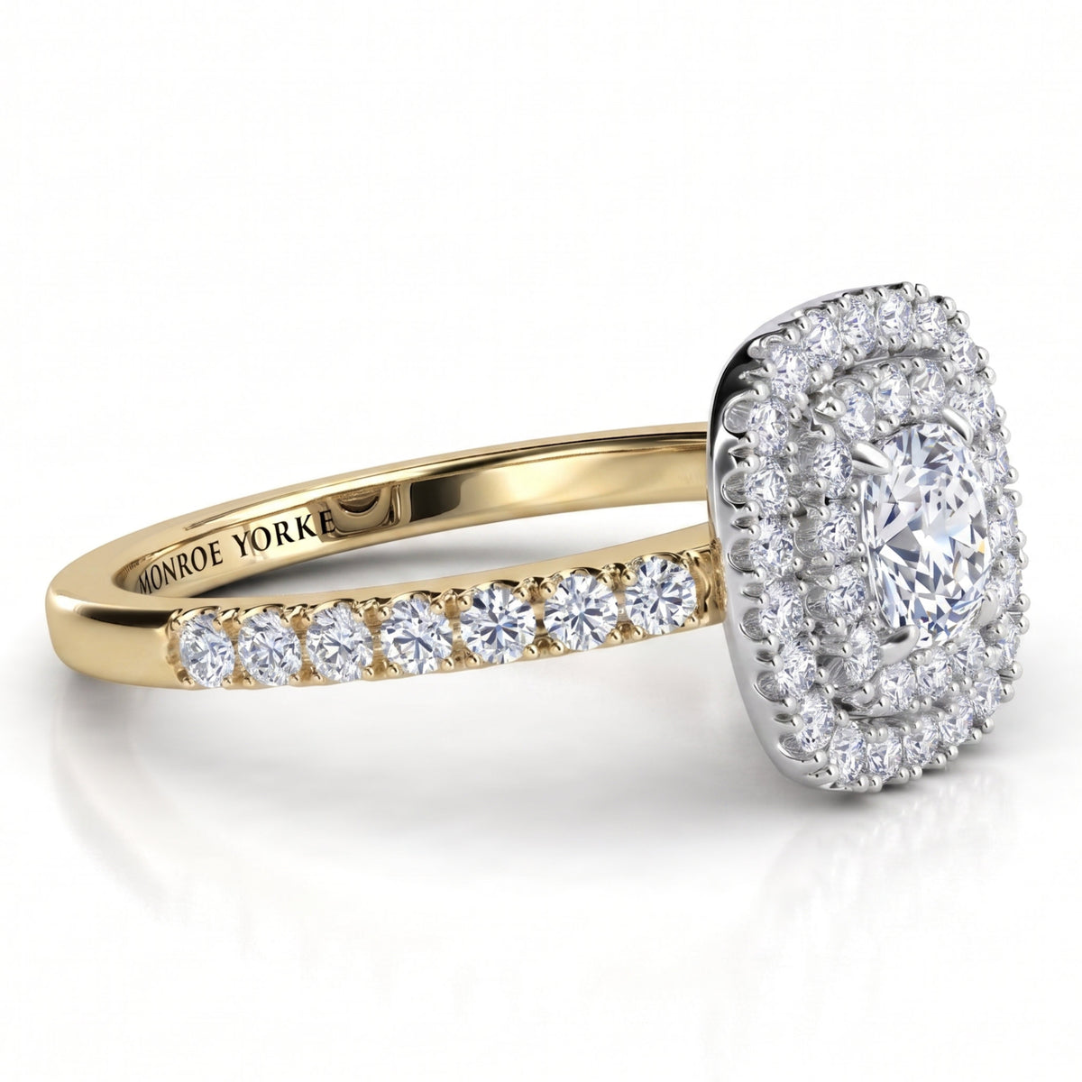 Norah cushion cut double halo engagement ring with a yellow gold band, angled side view showing the depth of the two halos in the white metal setting head.