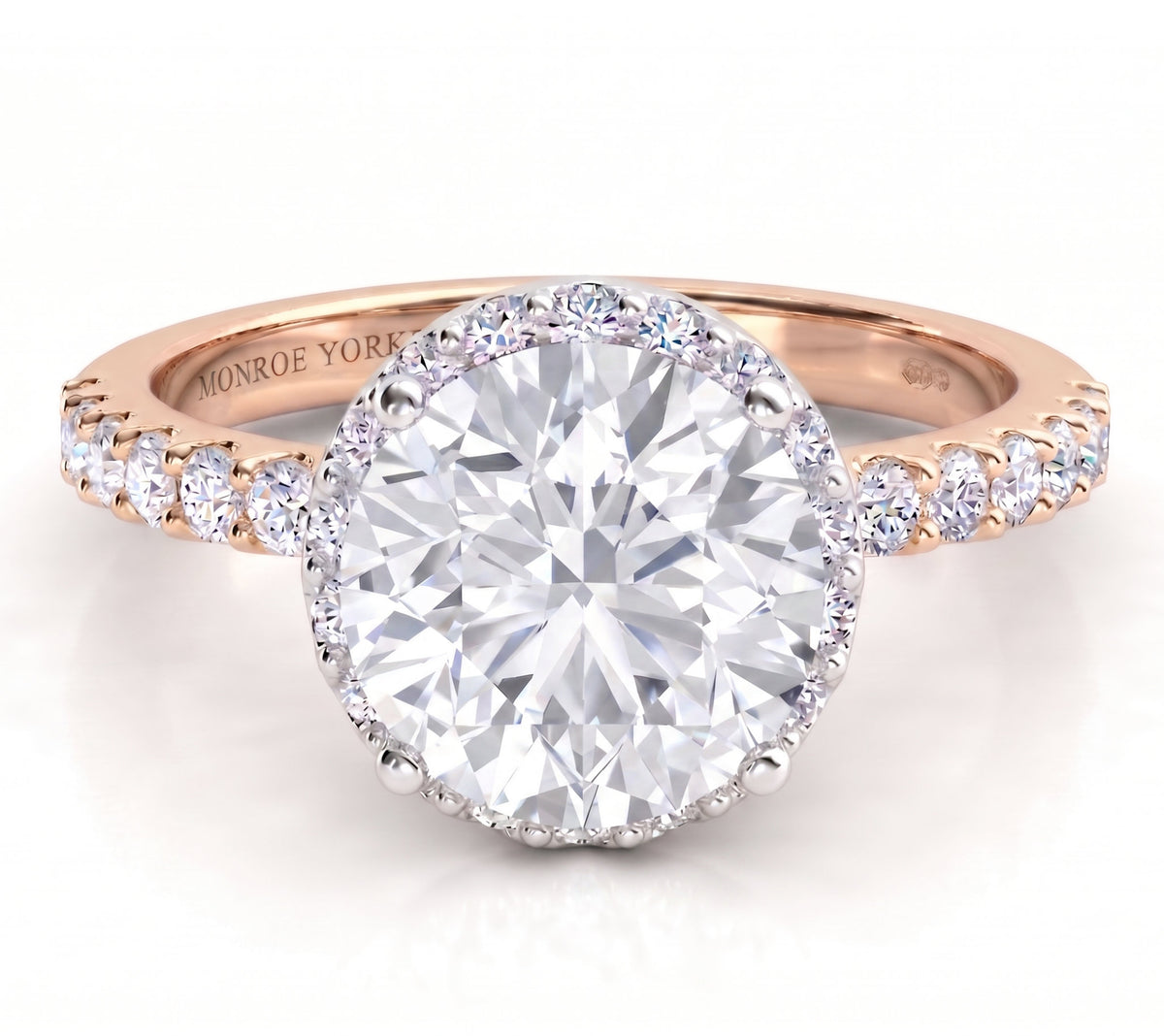 Orion rose gold engagement ring, round brilliant centre diamond above a hidden halo of smaller diamonds, with micro claw set diamonds along the band.