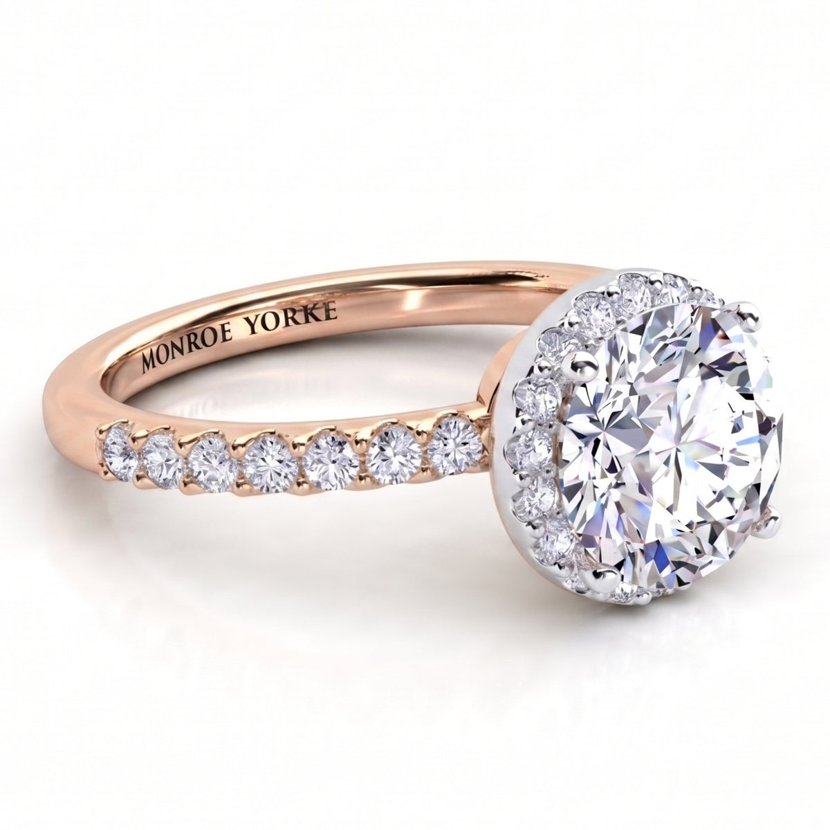 Orion rose gold engagement ring, side view of the round centre diamond, the hidden halo beneath it and the diamond set band.