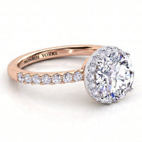 Orion rose gold engagement ring, side view of the round centre diamond, the hidden halo beneath it and the diamond set band.