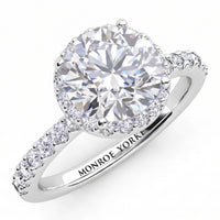 Orion engagement ring in white gold or platinum, top view of the round centre diamond and the diamond set band.
