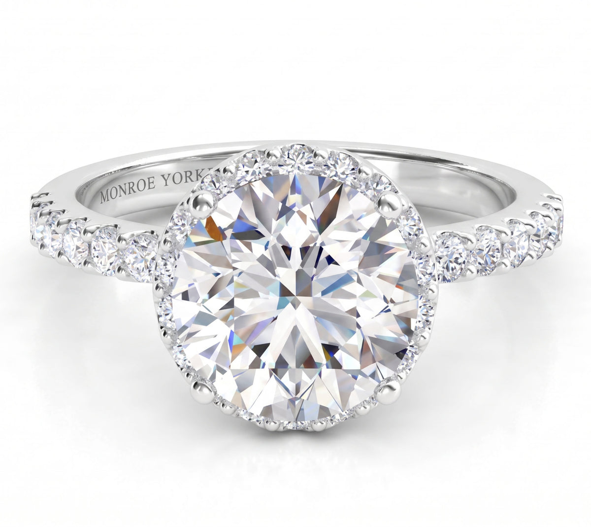 Orion engagement ring in white gold or platinum, hidden halo set just under the centre diamond with diamonds along the band.