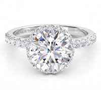 Orion engagement ring in white gold or platinum, hidden halo set just under the centre diamond with diamonds along the band.