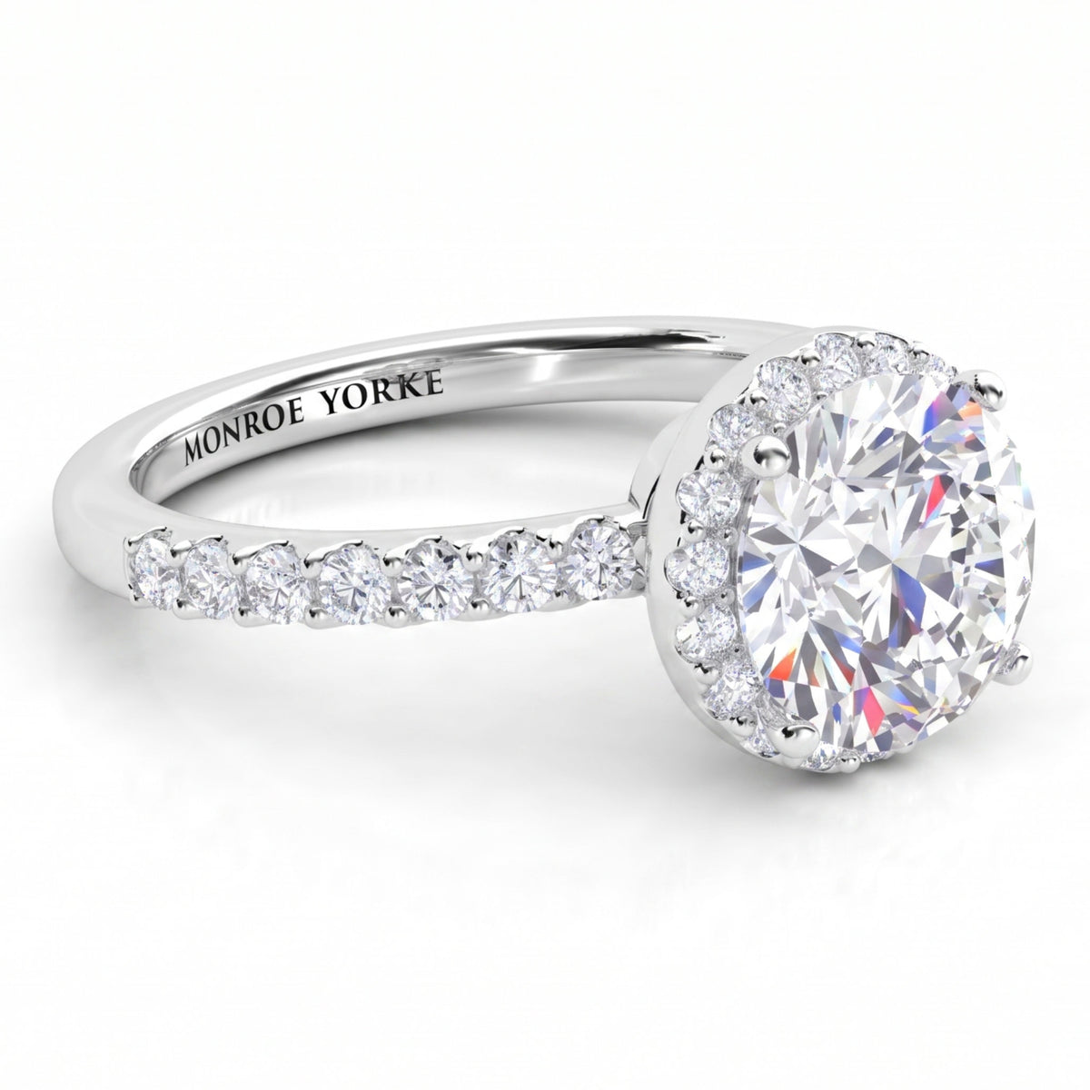 Orion engagement ring in white gold or platinum, hidden halo set under the girdle of the centre diamond.