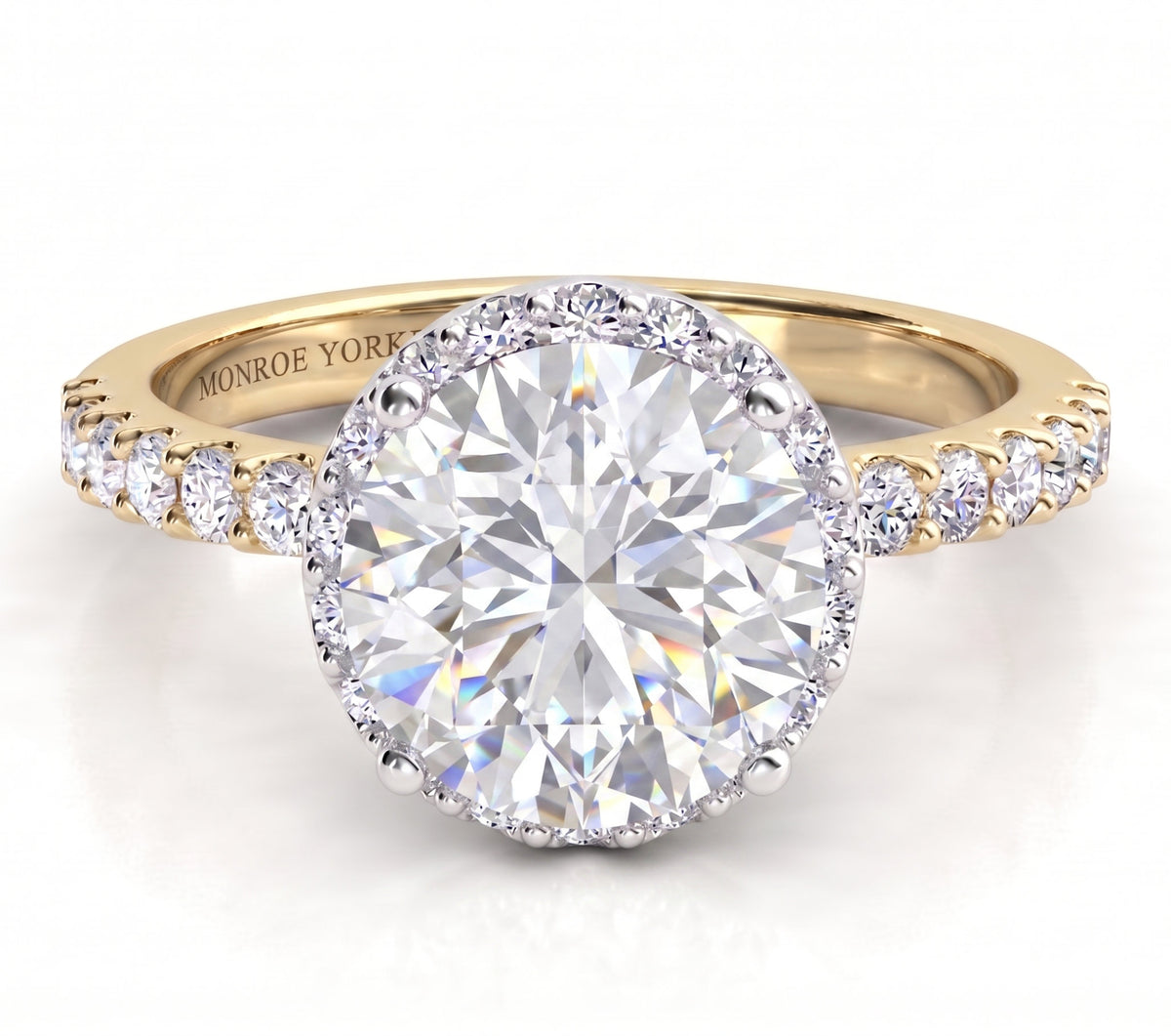 Orion yellow gold engagement ring, round centre diamond above a hidden halo of smaller diamonds, with micro claw set diamonds along the band.