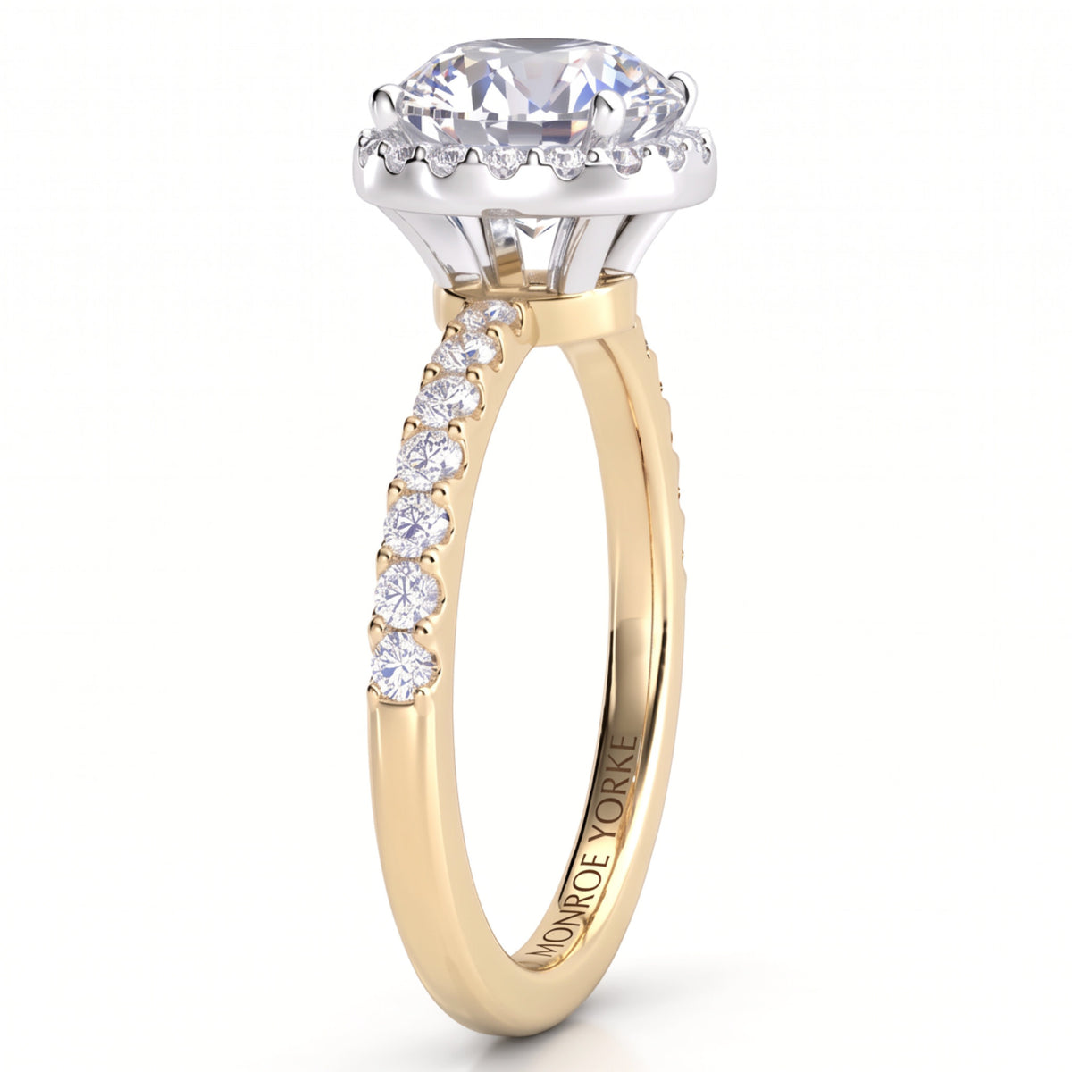 Orion yellow gold engagement ring, side view showing the hidden halo tucked under the centre diamond and five diamonds along each shoulder.