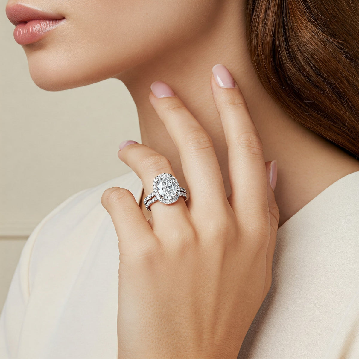 Laurel oval diamond halo engagement ring, angled detail of the halo and pave band