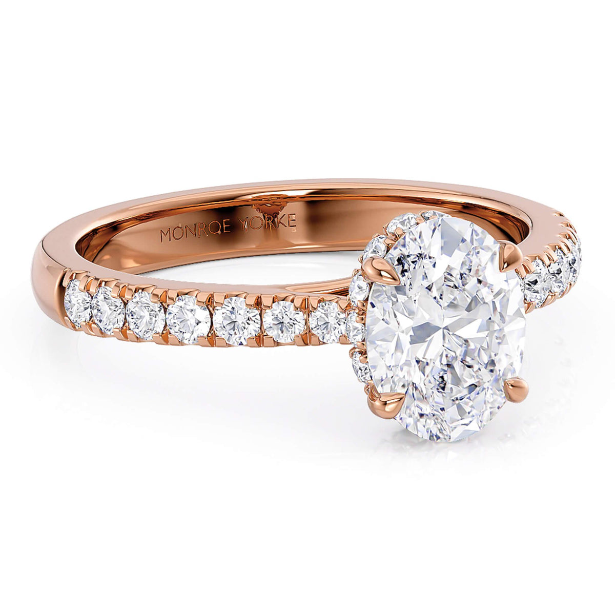 Paige hidden halo engagement ring in rose gold, angled view of the pave band