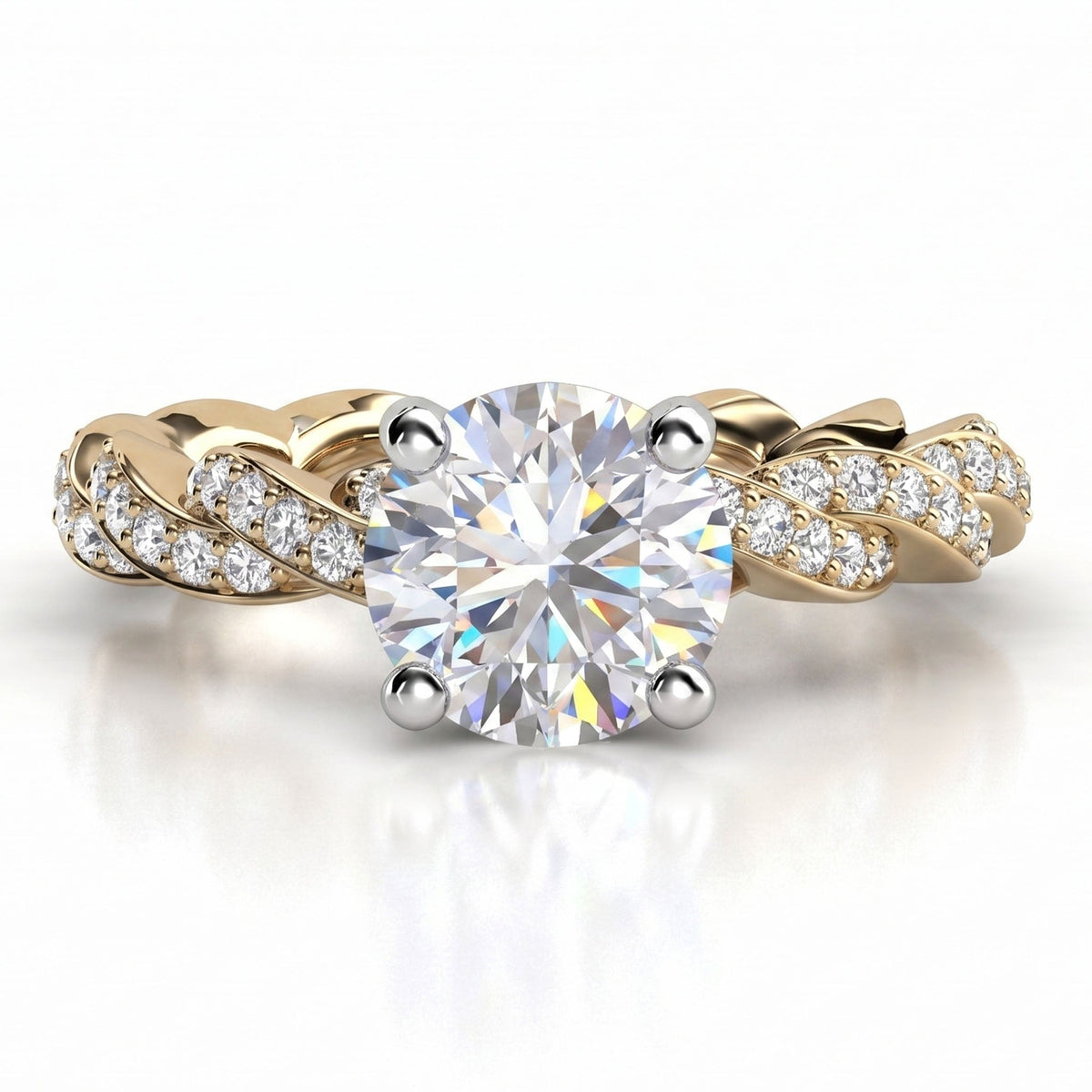 Quinn engagement ring in yellow gold. Round brilliant centre diamond above a braided pave-set band.