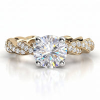 Quinn engagement ring in yellow gold. Round brilliant centre diamond above a braided pave-set band.
