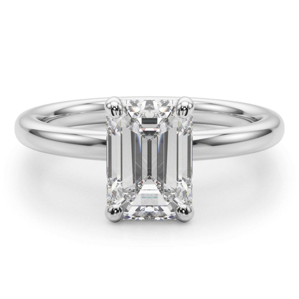 Skye front view - Emerald Cut Diamond solitaire ring with round claws. On a white gold or platinum band. 