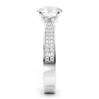 A white gold or platinum solitaire engagement ring featuring a large round brilliant-cut center stone and a pavé-set diamond band, shown on a solid white background.