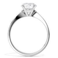 A classic solitaire engagement ring featuring a round brilliant-cut diamond set in a polished white gold or platinum band, shown against a solid white background.