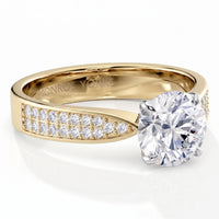Sophia - A yellow gold solitaire diamond engagement ring with a round brilliant-cut center stone and pavé-set diamonds along the band, shown on a clean white background. 